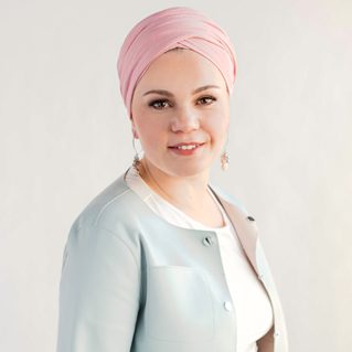 woman in pink head wrap and light blue suit Hera Hub Phoenix