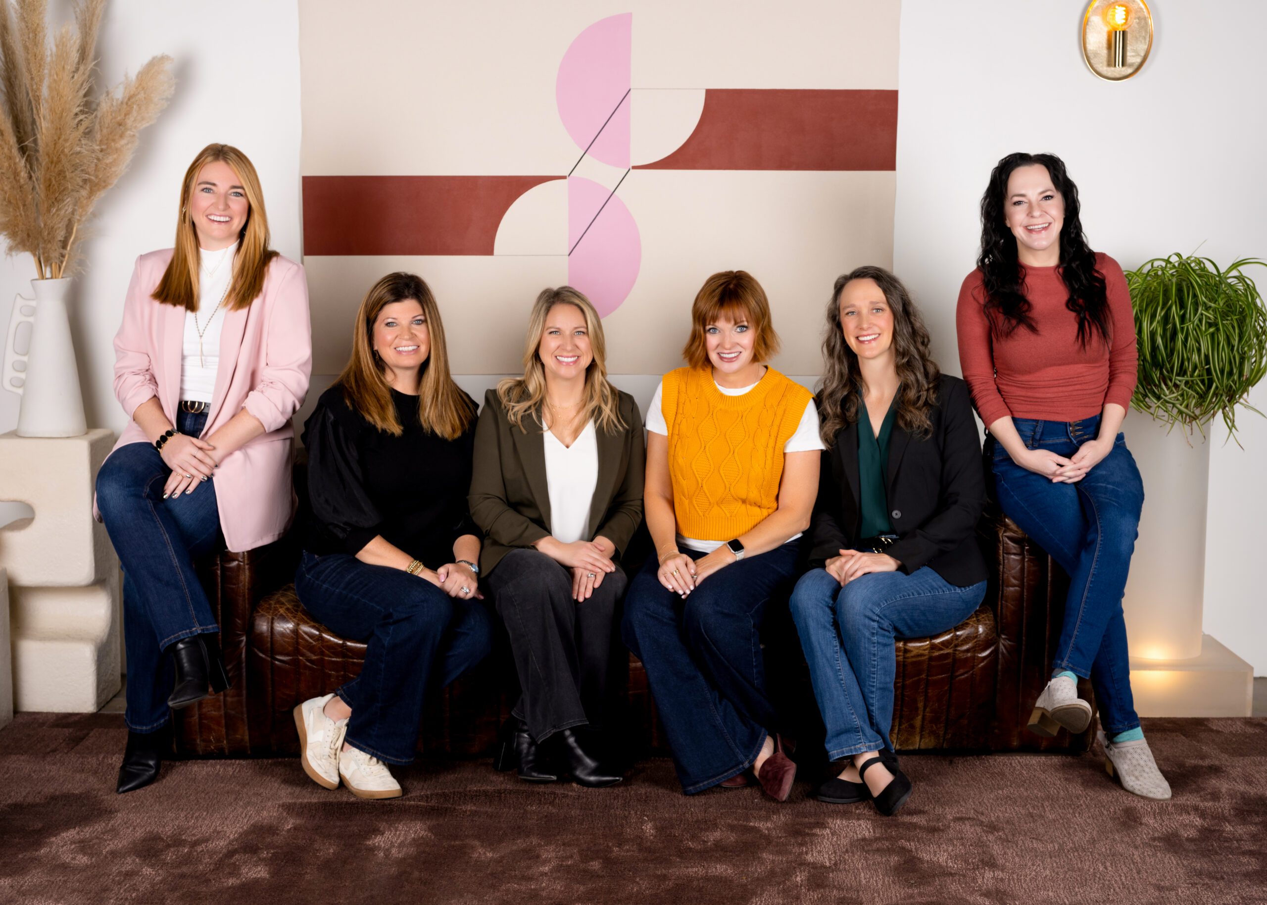 Hammersmith Support team members seated together in a modern office.